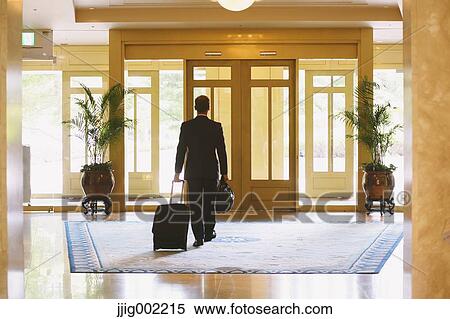 Businessman leaving hotel View Large Photo Image Stock Photography - Businessman leaving hotel. Fotosearch