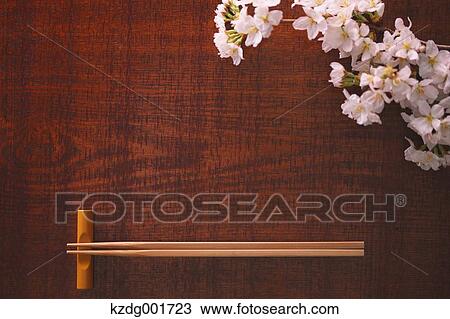Stock Image - Chopsticks and cherry blossoms. Fotosearch