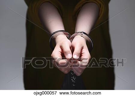 Stock Photo - Handcuffed arms. Fotosearch