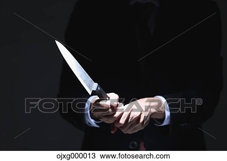 Stock Image - Japanese businessman holding kitchen knife. Fotosearch