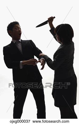 Japanese businesswoman holding kitchen knife against colleague View Large Photo Image Stock Photo - Japanese businesswoman holding kitchen knife against colleague. Fotosearch