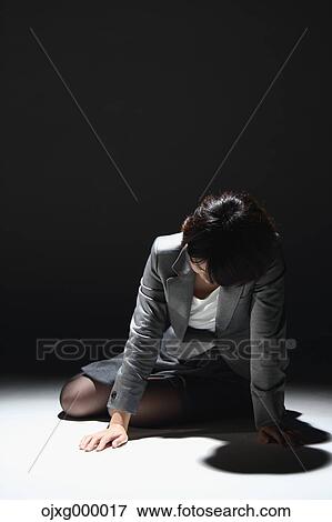 Japanese businesswoman in a suit laying on the ground View Large Photo Image Stock Photo - Japanese businesswoman in a suit laying on the ground. Fotosearch