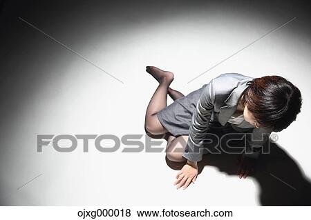 Japanese businesswoman in a suit laying on the ground View Large Photo Image Stock Photo - Japanese businesswoman in a suit laying on the ground. Fotosearch