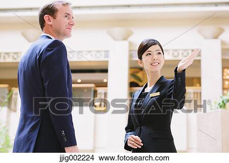 Japanese female hotel concierge dealing with a customer View Large Photo Image Picture - Japanese female hotel concierge dealing with a customer. Fotosearch