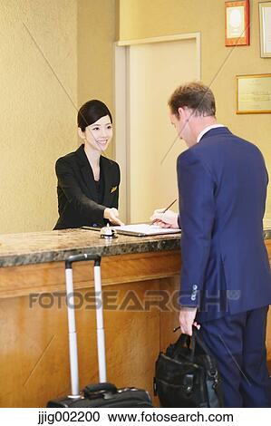 Japanese female hotel concierge dealing with a customer View Large Photo Image Stock Image - Japanese female hotel concierge dealing with a customer. Fotosearch