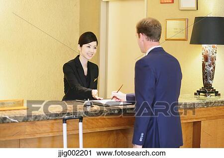 Japanese female hotel concierge dealing with a customer View Large Photo Image Stock Image - Japanese female hotel concierge dealing with a customer. Fotosearch