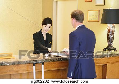 Japanese female hotel concierge dealing with a customer View Large Photo Image Stock Image - Japanese female hotel concierge dealing with a customer. Fotosearch