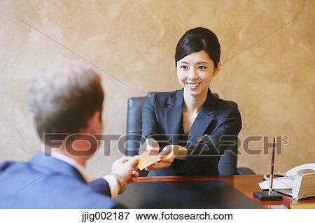 Japanese female hotel concierge dealing with a customer View Large Photo Image Stock Photo - Japanese female hotel concierge dealing with a customer. Fotosearch