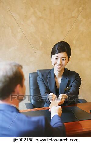 Japanese female hotel concierge dealing with a customer View Large Photo Image Stock Photo - Japanese female hotel concierge dealing with a customer. Fotosearch