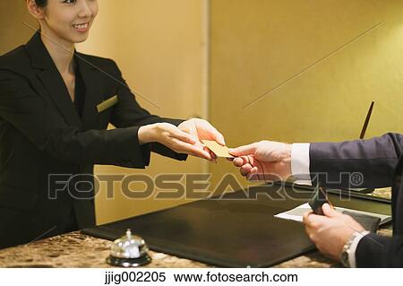 Japanese female hotel concierge dealing with a customer View Large Photo Image Stock Photography - Japanese female hotel concierge dealing with a customer. Fotosearch