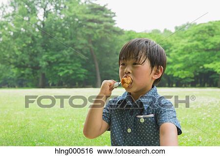 Stock Photograph - Japanese kid having picnic in a park. Fotosearch