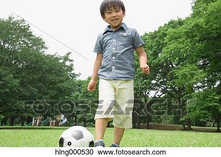 Stock Image - Japanese kid playing in a park. Fotosearch