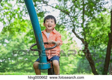 Stock Image - Japanese kid playing in a park. Fotosearch