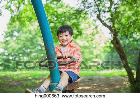 Stock Image - Japanese kid playing in a park. Fotosearch