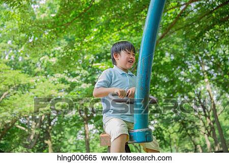 Japanese kid playing in a park View Large Photo Image Stock Photography - Japanese kid playing in a park. Fotosearch