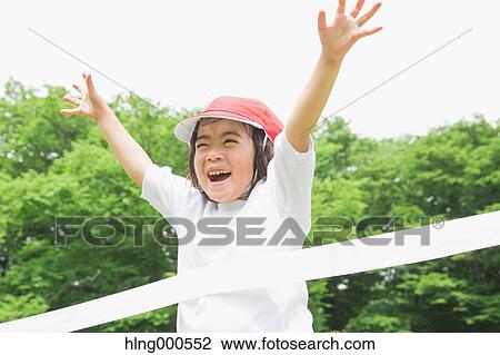 Stock Image - Japanese kid running in a park. Fotosearch