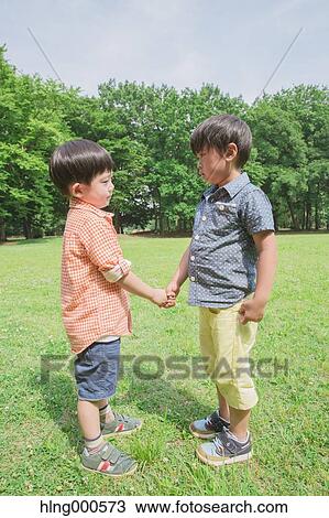 Japanese kid shaking hands in a park View Large Photo Image Stock Image - Japanese kid shaking hands in a park. Fotosearch
