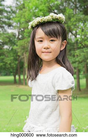 Japanese kid with flower tiara in a park View Large Photo Image Stock Image - Japanese kid with flower tiara in a park. Fotosearch