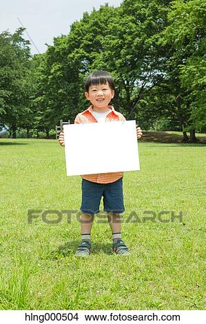 Picture - Japanese kid with whiteboard in a park. Fotosearch