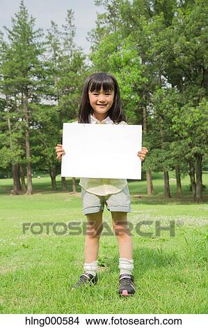 Japanese kid with whiteboard in a park View Large Photo Image Picture - Japanese kid with whiteboard in a park. Fotosearch