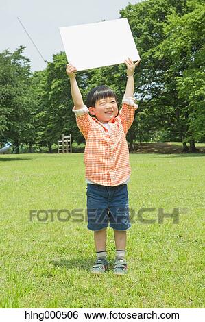 Japanese kid with whiteboard in a park View Large Photo Image Stock Photograph - Japanese kid with whiteboard in a park. Fotosearch