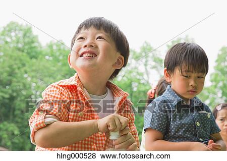 Japanese kids having picnic in a park View Large Photo Image Stock Photo - Japanese kids having picnic in a park. Fotosearch