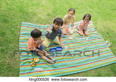 Stock Photograph - Japanese kids having picnic in a park. Fotosearch