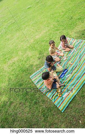 Stock Photography - Japanese kids having picnic in a park. Fotosearch