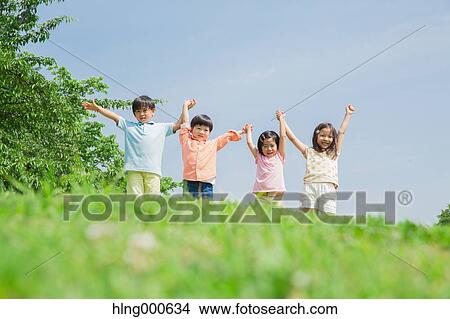 Picture - Japanese kids playing in a park. Fotosearch
