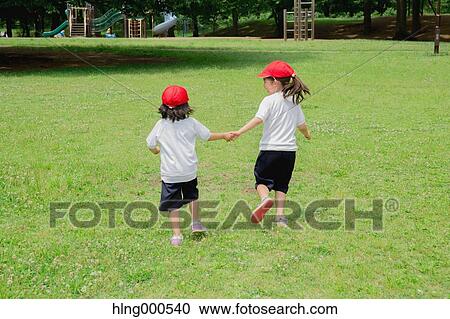 Stock Image - Japanese kids playing in a park. Fotosearch