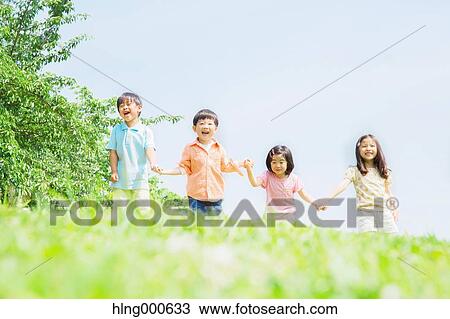Stock Image - Japanese kids playing in a park. Fotosearch