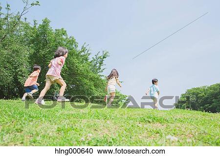 Stock Image - Japanese kids playing in a park. Fotosearch