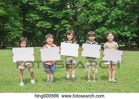 Japanese kids with whiteboard in a park View Large Photo Image Stock Photograph - Japanese kids with whiteboard in a park. Fotosearch