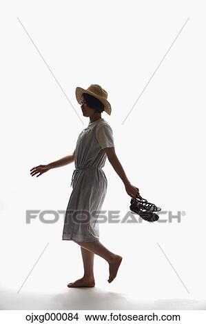 Picture - Japanese woman in a one-piece walking. Fotosearch