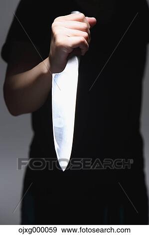 Stock Photo - Man holding kitchen knife. Fotosearch