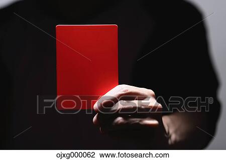 Stock Image - Man holding red card. Fotosearch