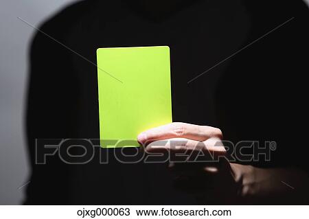 Man holding yellow card View Large Photo Image Stock Image - Man holding yellow card. Fotosearch