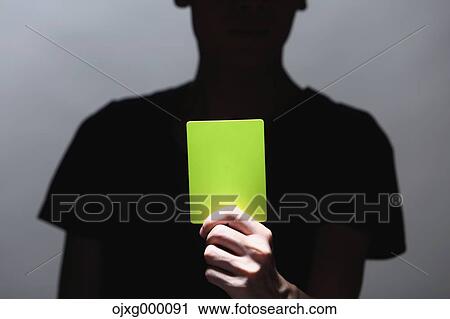 Man holding yellow card View Large Photo Image Stock Image - Man holding yellow card. Fotosearch