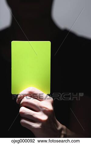 Man holding yellow card View Large Photo Image Stock Image - Man holding yellow card. Fotosearch