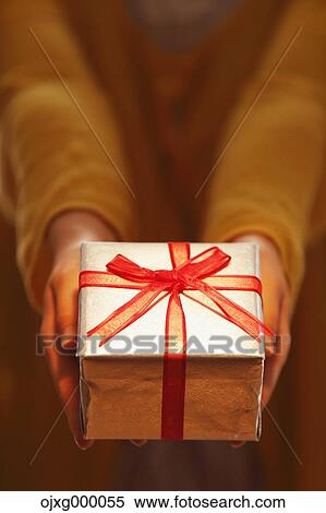Woman giving gift View Large Photo Image Stock Photography - Woman giving gift. Fotosearch