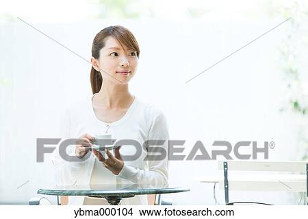 Attractive young girl having coffee outside View Large Photo Image Picture - Attractive young girl having coffee outside. Fotosearch
