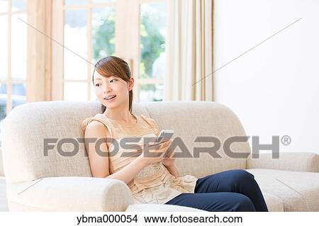 Attractive young girl with smartphone View Large Photo Image Picture - Attractive young girl with smartphone. Fotosearch