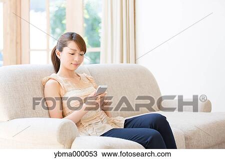 Attractive young girl with smartphone View Large Photo Image Stock Image - Attractive young girl with smartphone. Fotosearch