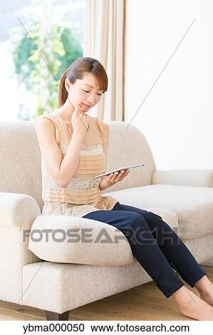 Attractive young girl with tablet View Large Photo Image Stock Image - Attractive young girl with tablet. Fotosearch