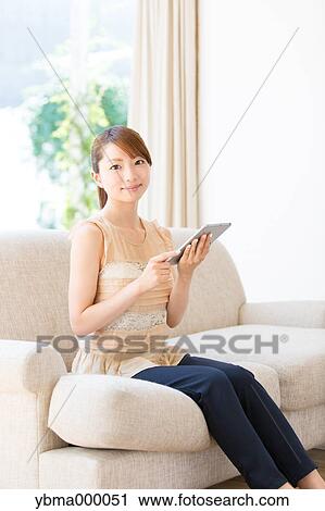Stock Image - Attractive young girl with tablet. Fotosearch