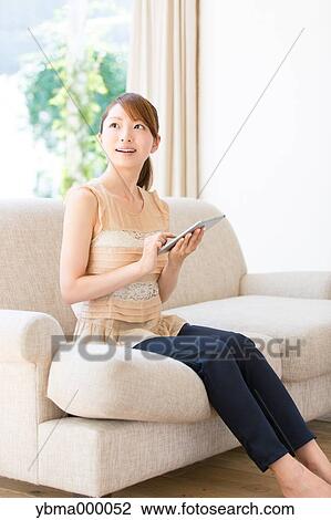 Stock Image - Attractive young girl with tablet. Fotosearch