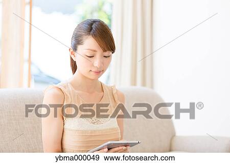 Stock Photo - Attractive young girl with tablet. Fotosearch
