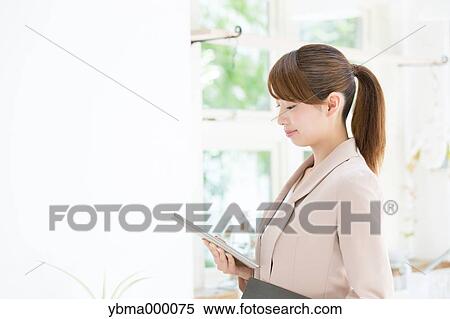 Attractive young girl with tablet View Large Photo Image Stock Photography - Attractive young girl with tablet. Fotosearch