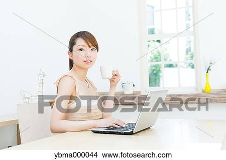 Attractive young girl working with laptop View Large Photo Image Picture - Attractive young girl working with laptop. Fotosearch