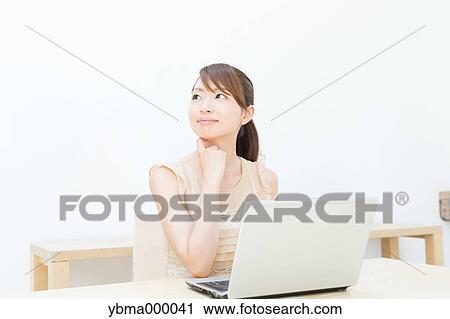 Attractive young girl working with laptop View Large Photo Image Stock Image - Attractive young girl working with laptop. Fotosearch